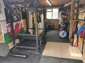 James Patel's four-post 3×3 steel power rack in his Cardiff home gym.