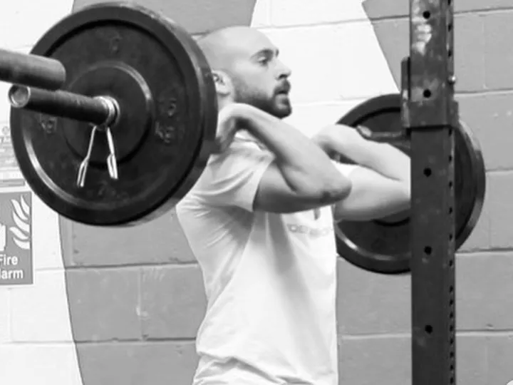 Miles B lifting in his own home gym.